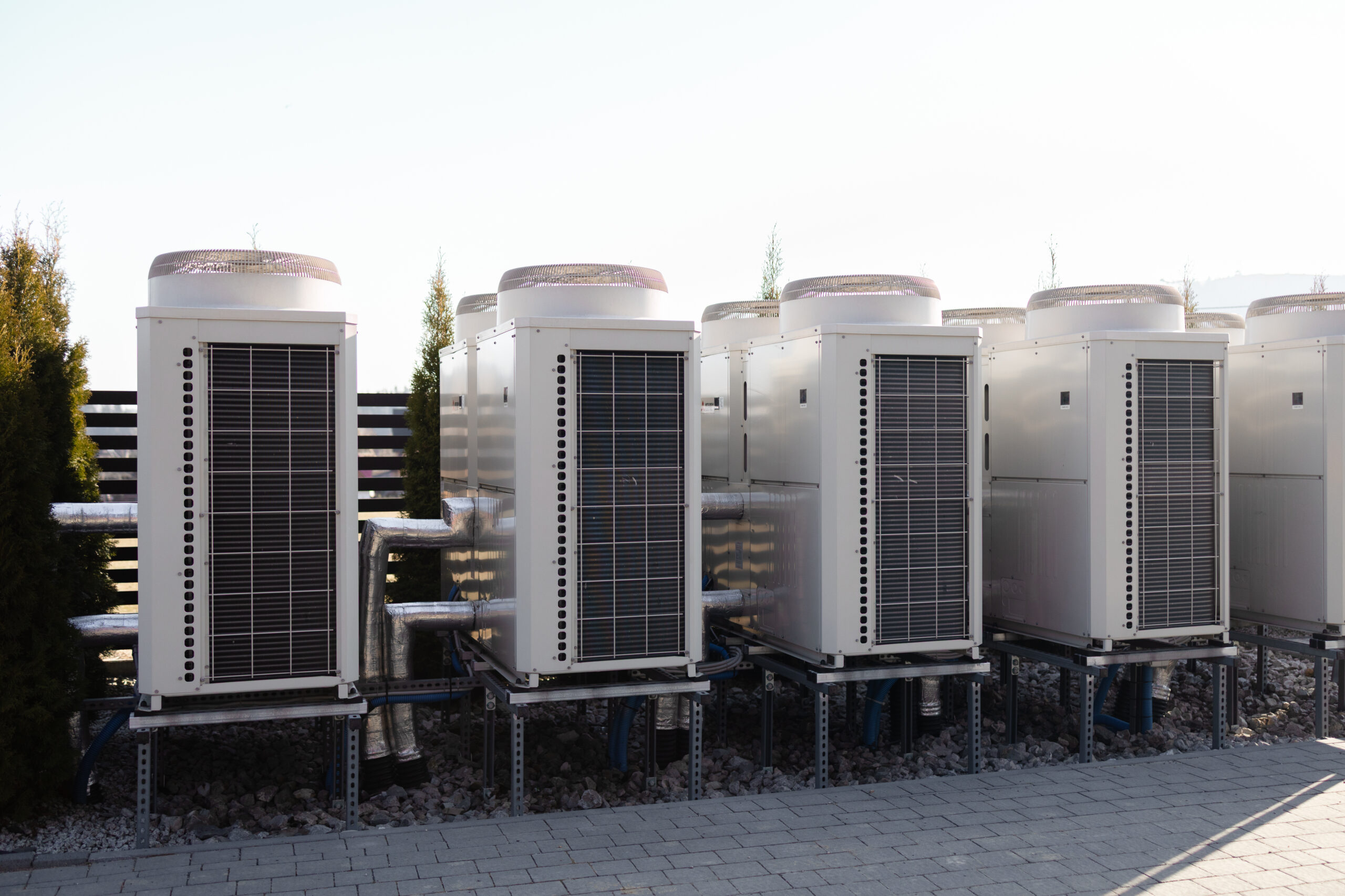 Row of industrial air conditioning outdoor units near building